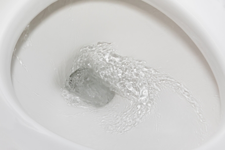 Motion blur of flushing water in toilet bowl. Plumbing